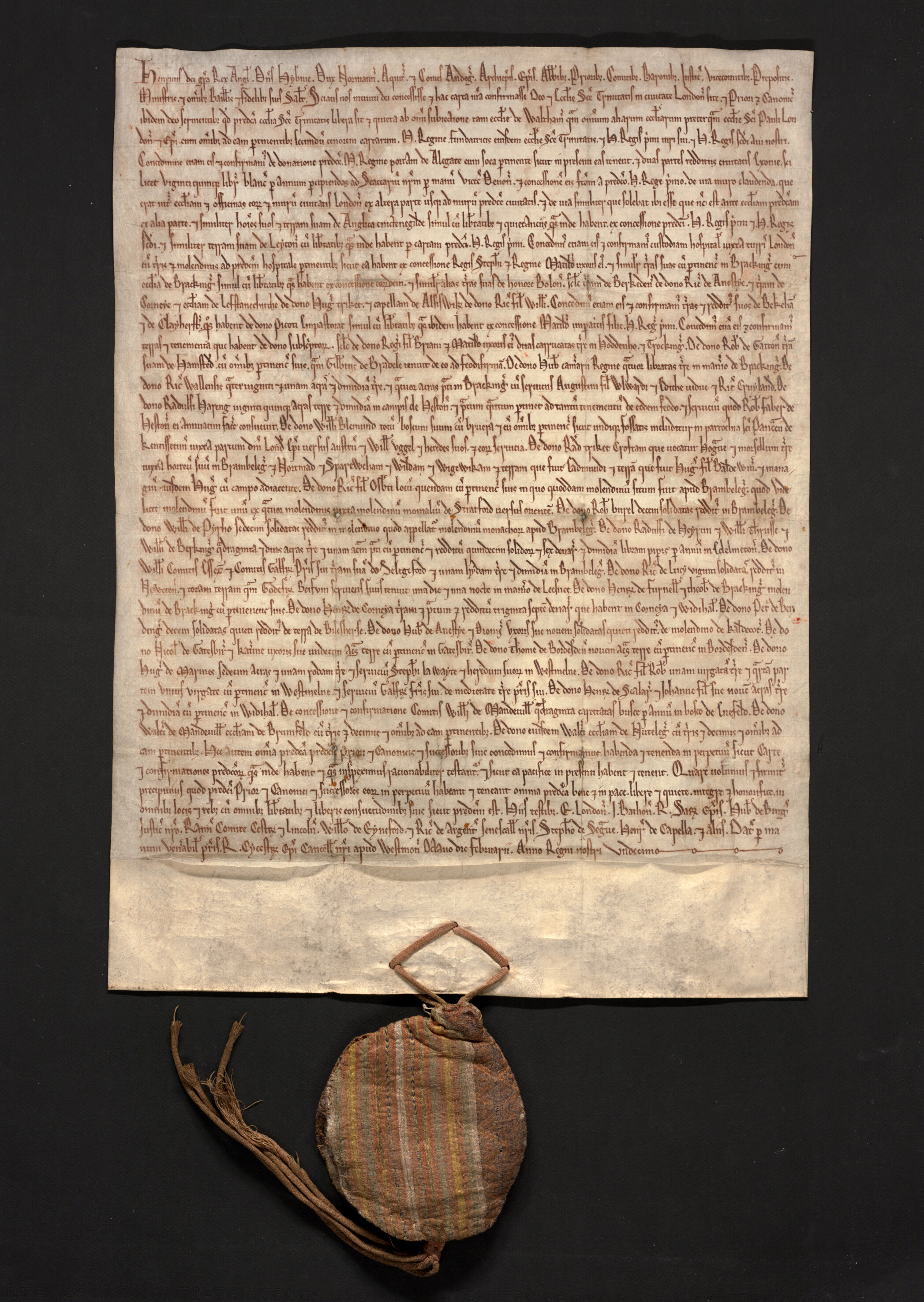 Parchment charter (Holy Trinity) of which the seal is wrapped in a multi-coloured stripedsilk bag.