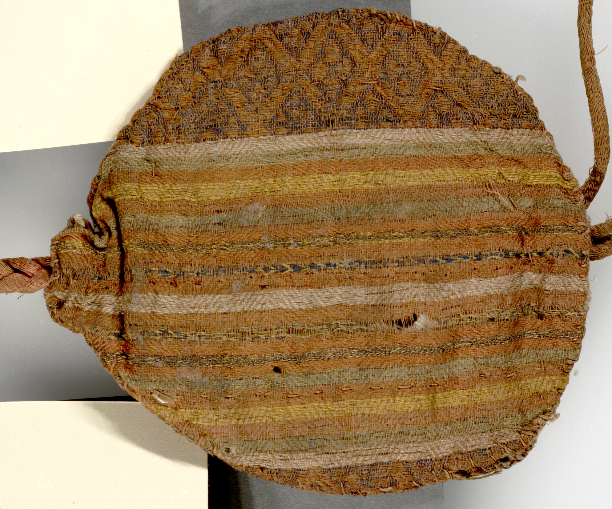 Front of the Holy Trinity pouch rotated showing the weft of the fabric creating horizontal, parallel bands with a herringbone patterned weave (cloth of Arista).